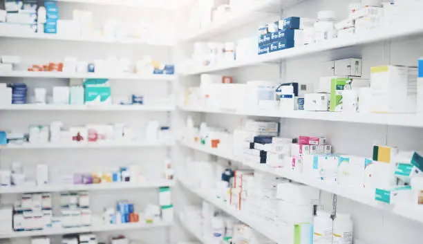 Organized pharmacy medication shelves representing controlled substance inventory